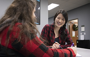 Two Women Sitting at Table Two Women Sitting at Table