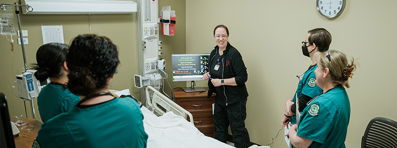 Male professor teaching students in a classroom