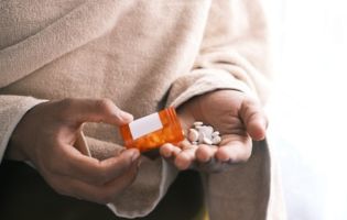 Someone Pouring Pills Into Their Hands Someone Pouring Pills Into Their Hands