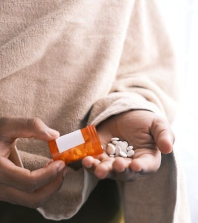 Person Pouring Pills Into Her Hand Person Pouring Pills Into Her Hand