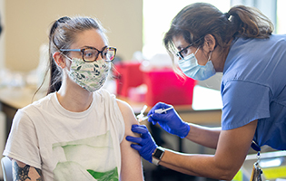 Nursing Giving Woman a Vaccine Nursing Giving Woman a Vaccine