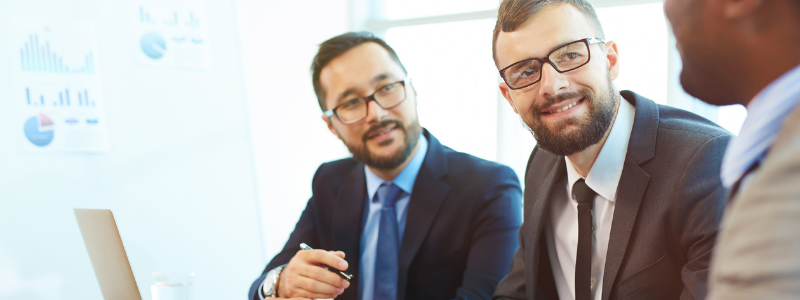 Three Men Sitting at a Table Three Men Sitting at a Table