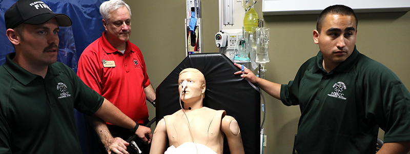 Three Men Around a Sitting Dummy Three Men Around a Sitting Dummy