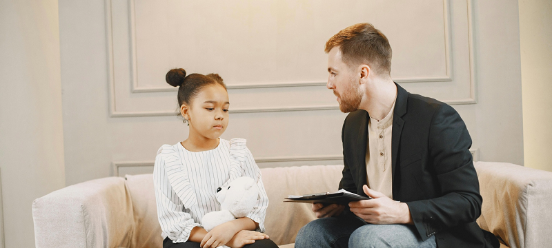 Health professional sitting with child