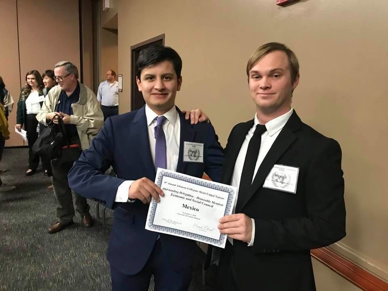 Two Male Students Holding Certificate
