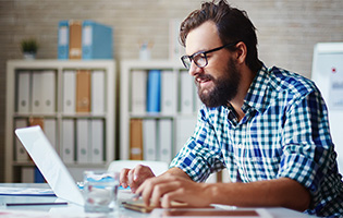 White Man Working on a Laptop White Man Working on a Laptop