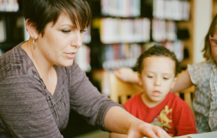 woman teaching young child