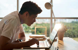 student studying on a laptop