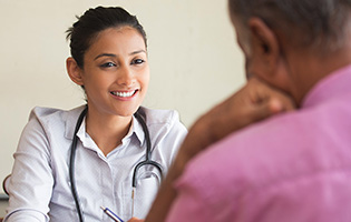 female in a white blouse with a stethoscope over her shoulders