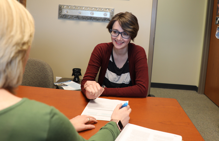 A Woman Sitting at a Desk A Woman Sitting at a Desk