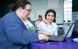 Staff Assisting a Student