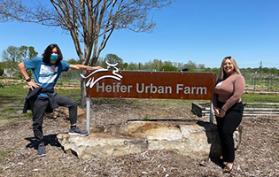 Student Standing Next to a Sign Student Standing Next to a Sign