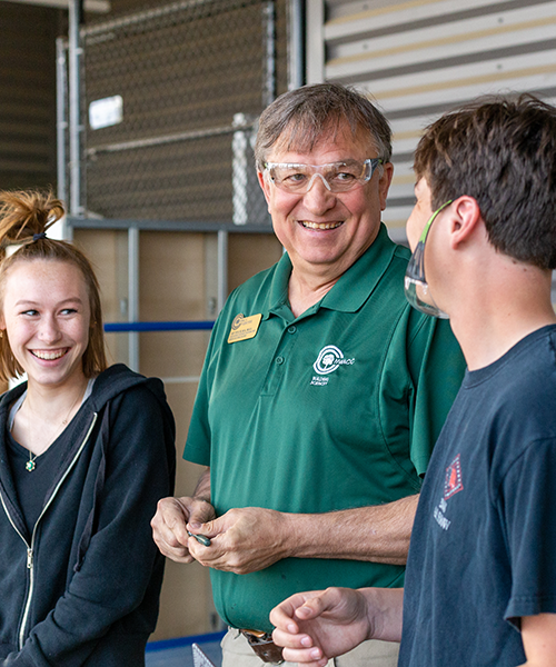Faculty member talking to students Faculty member talking to students