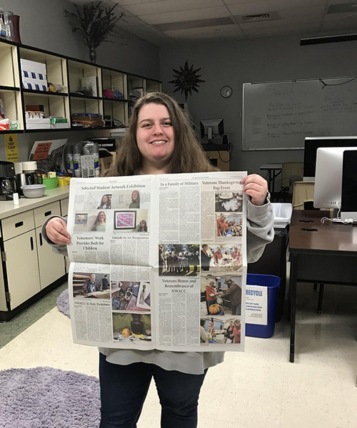 Image of Eagle View Student Holding 新闻paper 