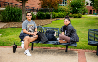 Two students sitting on a bench Two students sitting on a bench