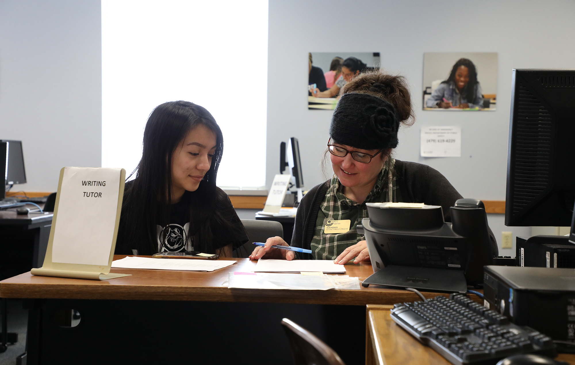 Mature woman tutoring a young female student in writing Mature woman tutoring a young female student in writing