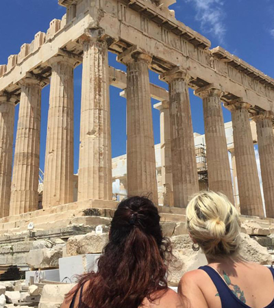 Two Women Looking Up at the Greek Acropolis Two Women Looking Up at the Greek Acropolis